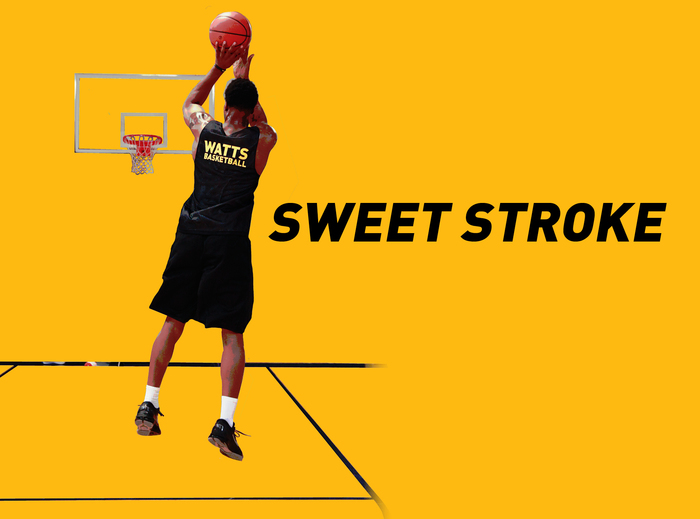 Basketball player midair shooting toward hoop
