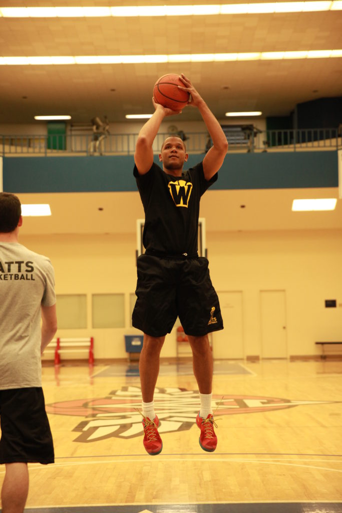 Basketball player shooting on indoor court