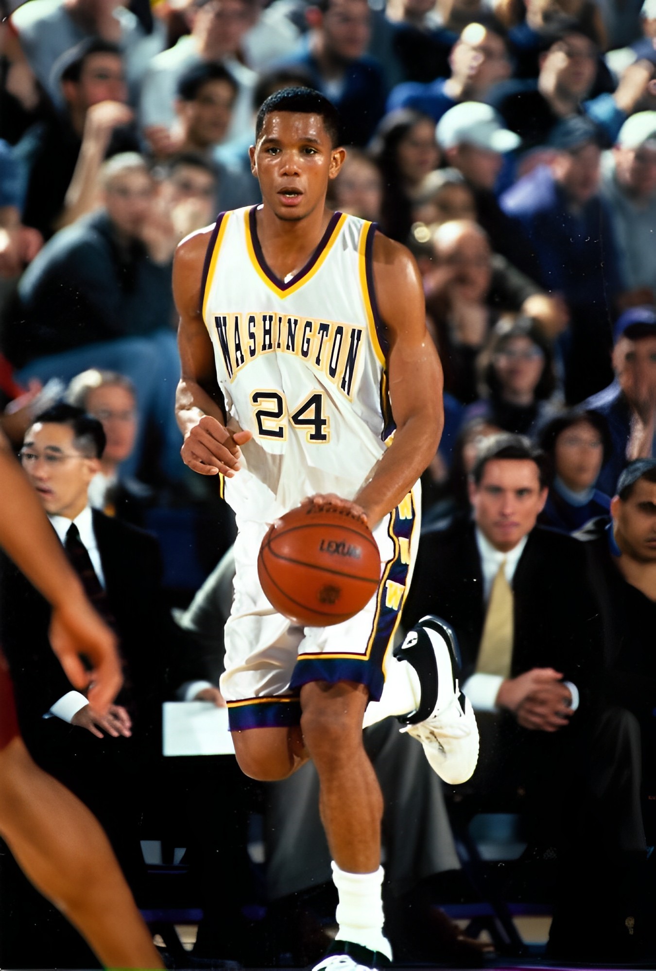 Washington basketball player dribbling during game